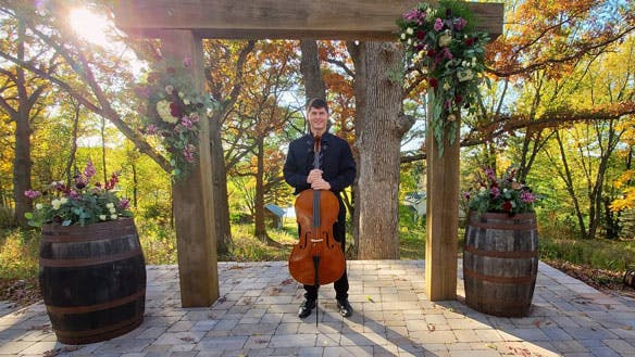 Brady playing cello at a wedding